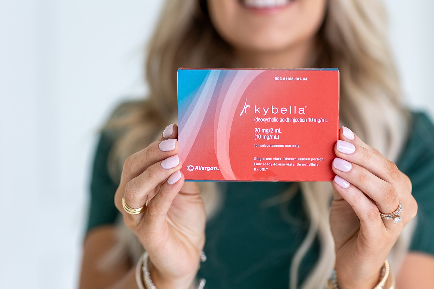 Kybella injection packaging in person’s hand.