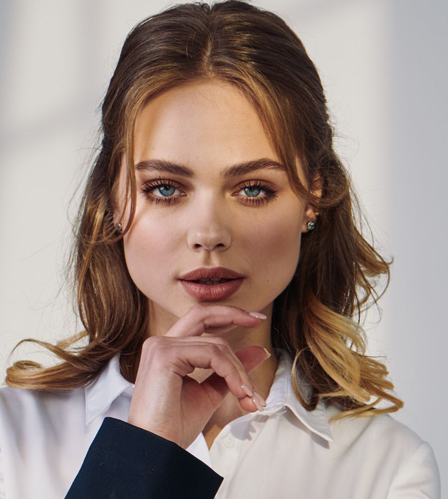 Close-up of a woman with thoughtful expression.