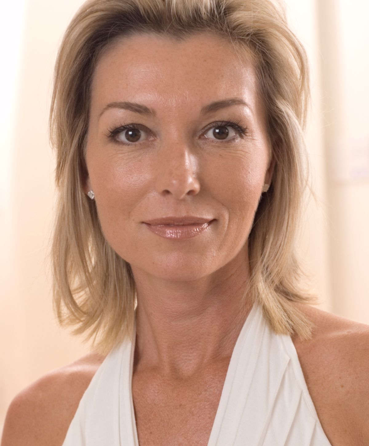 Smiling woman with blonde hair and light makeup.