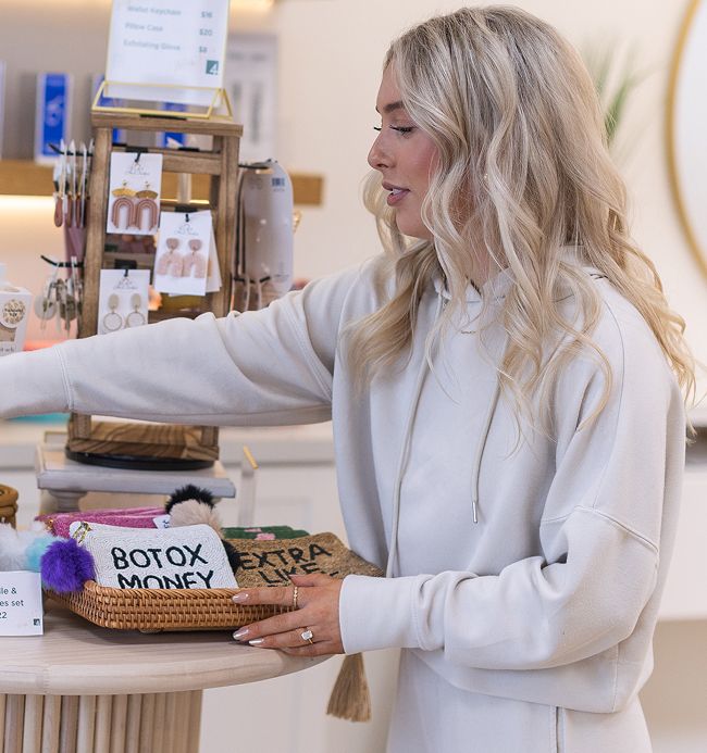 Woman shopping at a stylish boutique display.