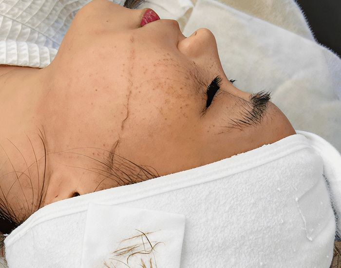 Model in stylish outfit with earrings.