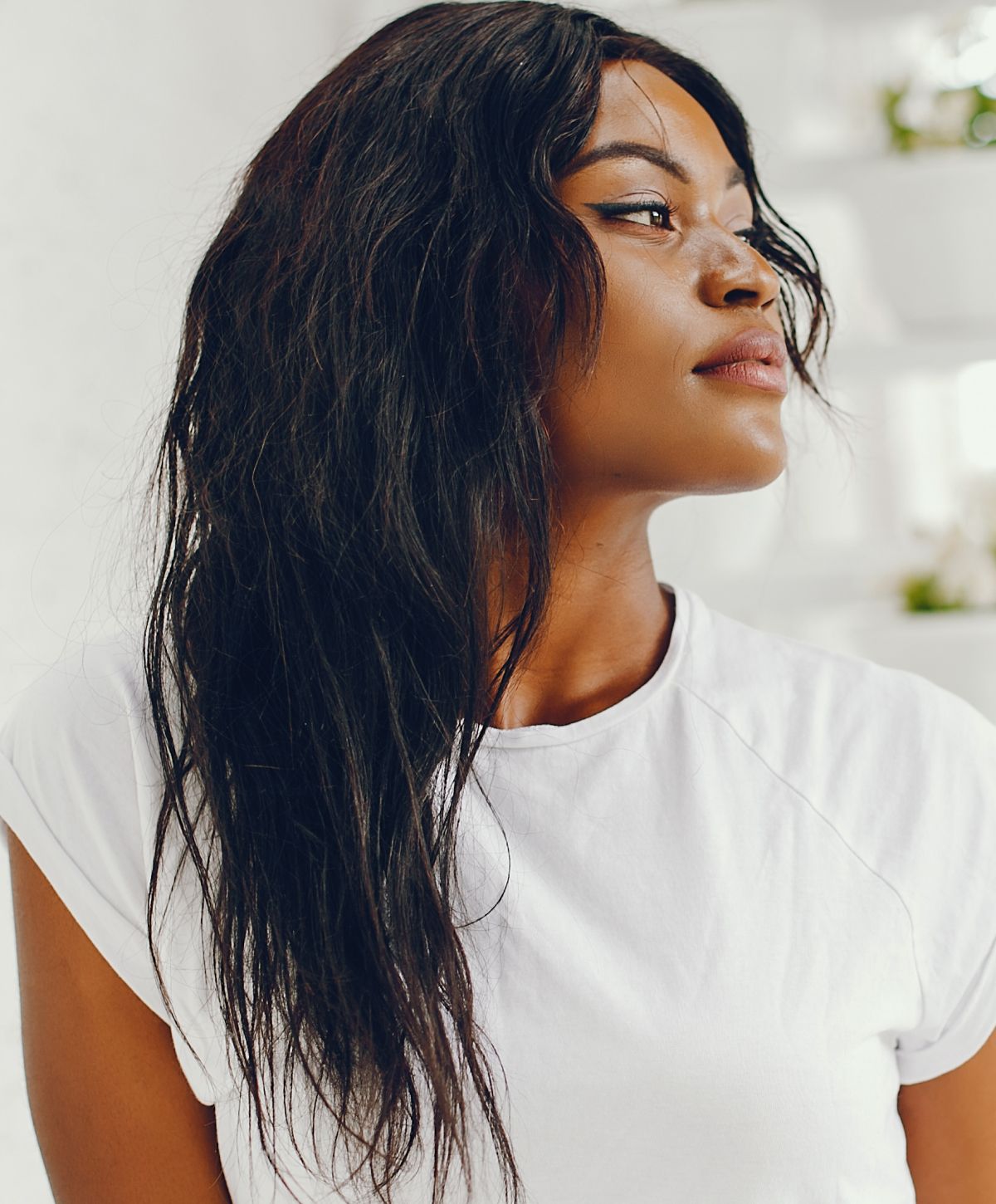 Woman with long, wavy hair in profile.