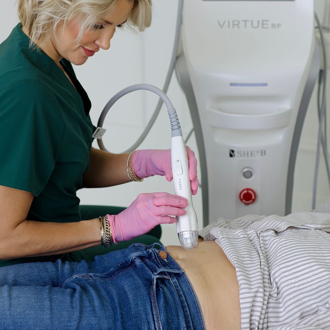 Medical professional using device for skin treatment.