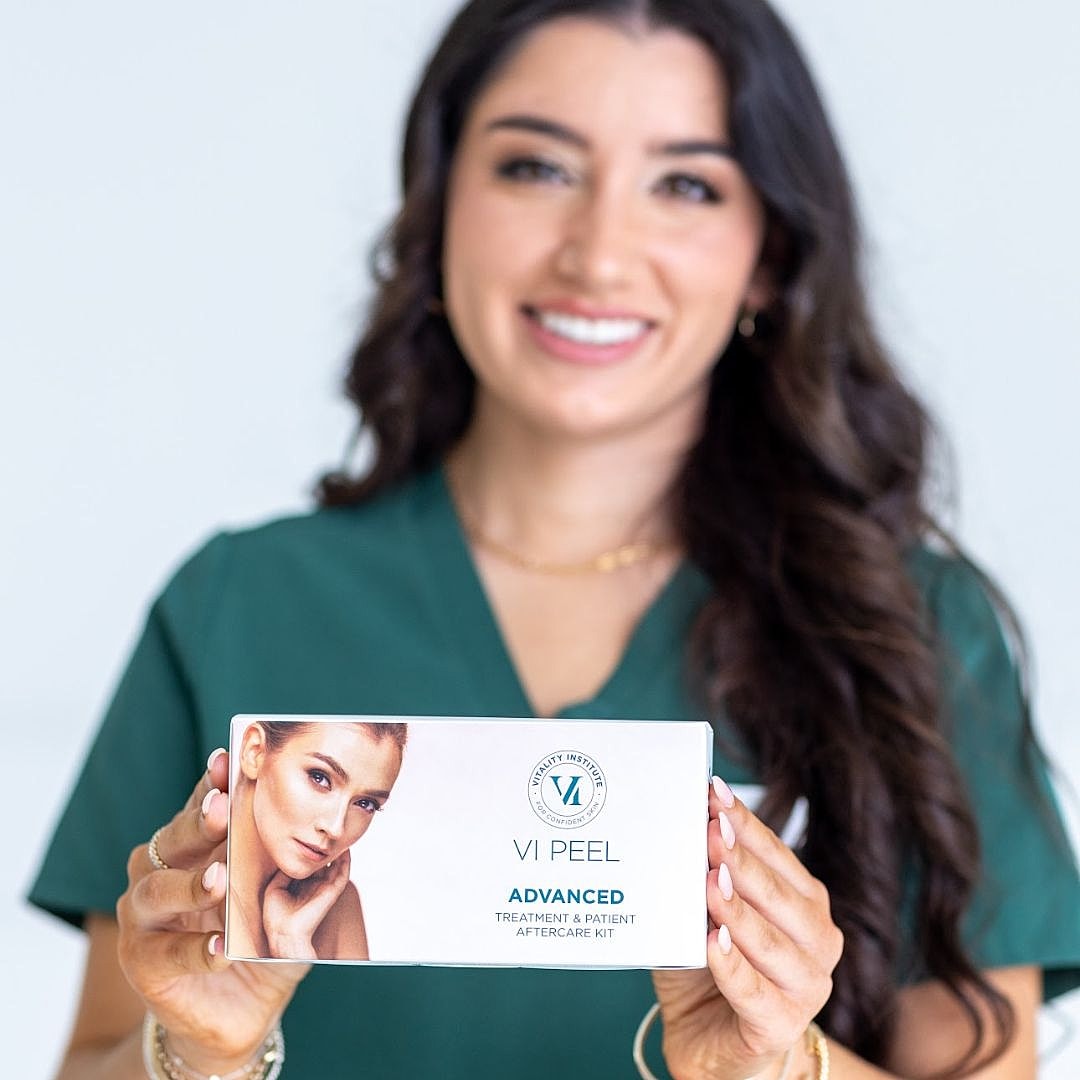 Woman holding VI Peel treatment kit.