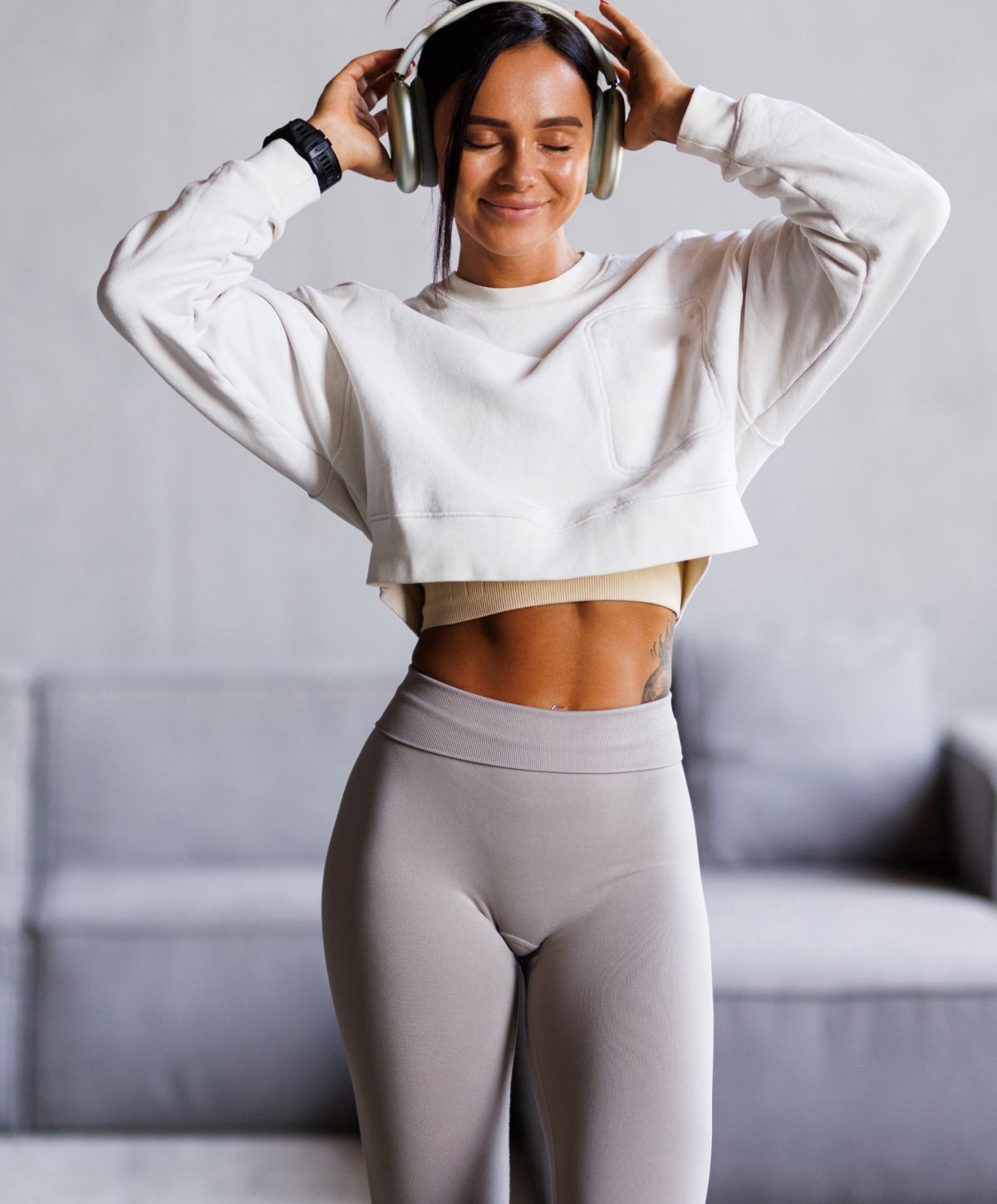 Woman enjoying music, wearing sportswear and headphones.