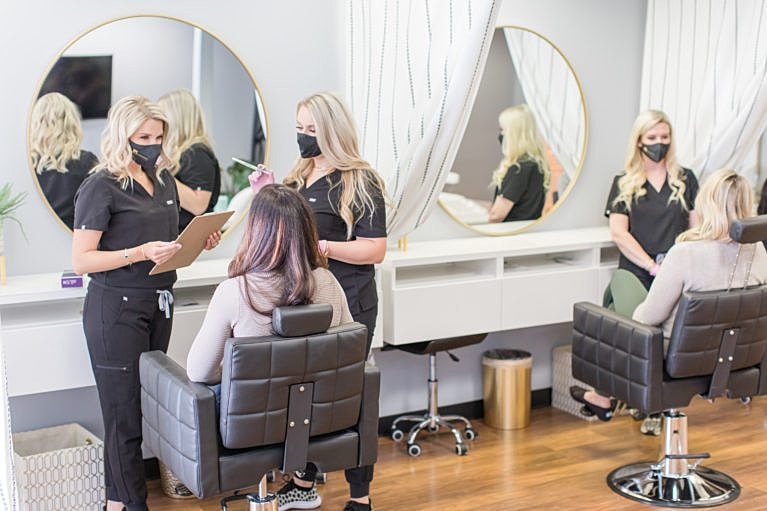 Hair salon consultation with stylists and clients.