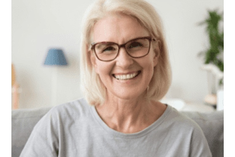 Smiling older woman with glasses at home