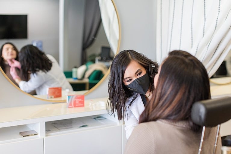 Dental consultation with masked professionals.