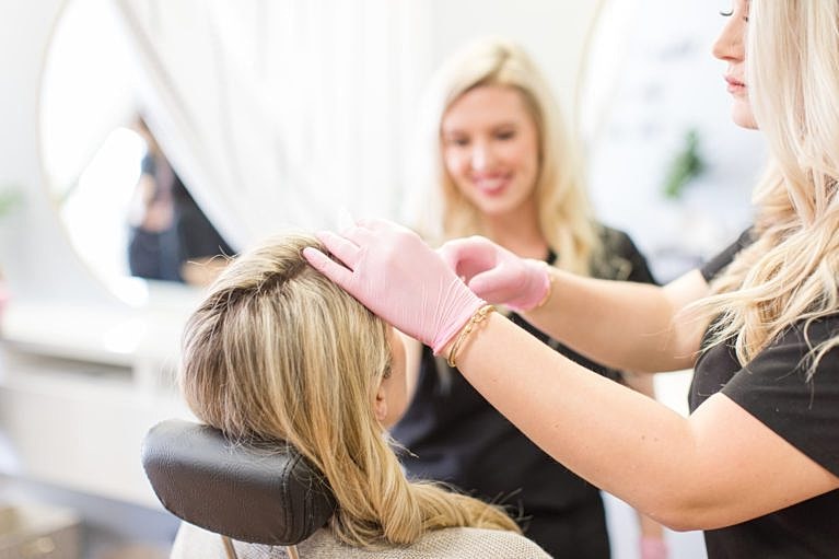 Hair treatment being applied in a salon.