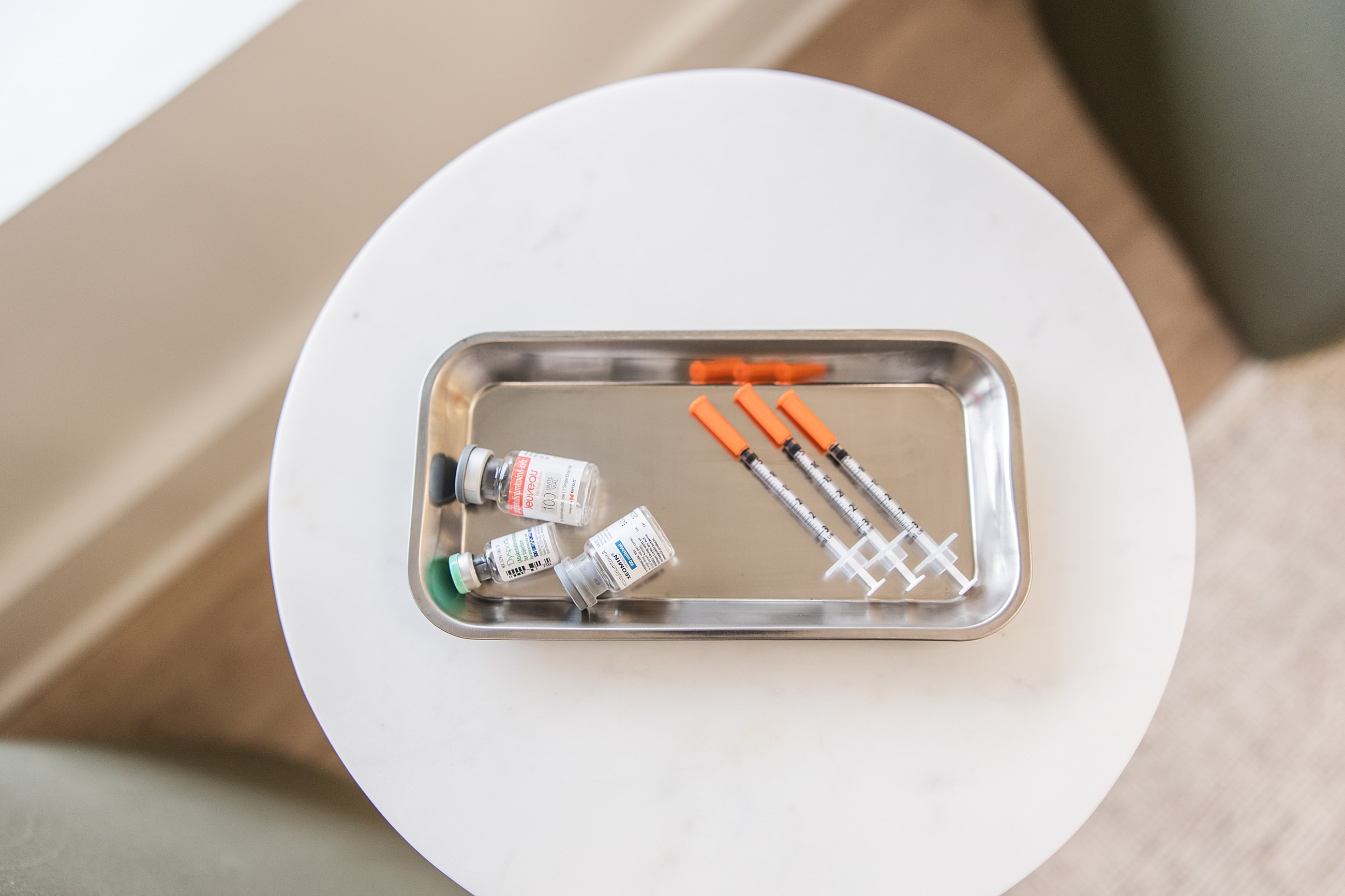 Vials and syringes on a tray for vaccination.
