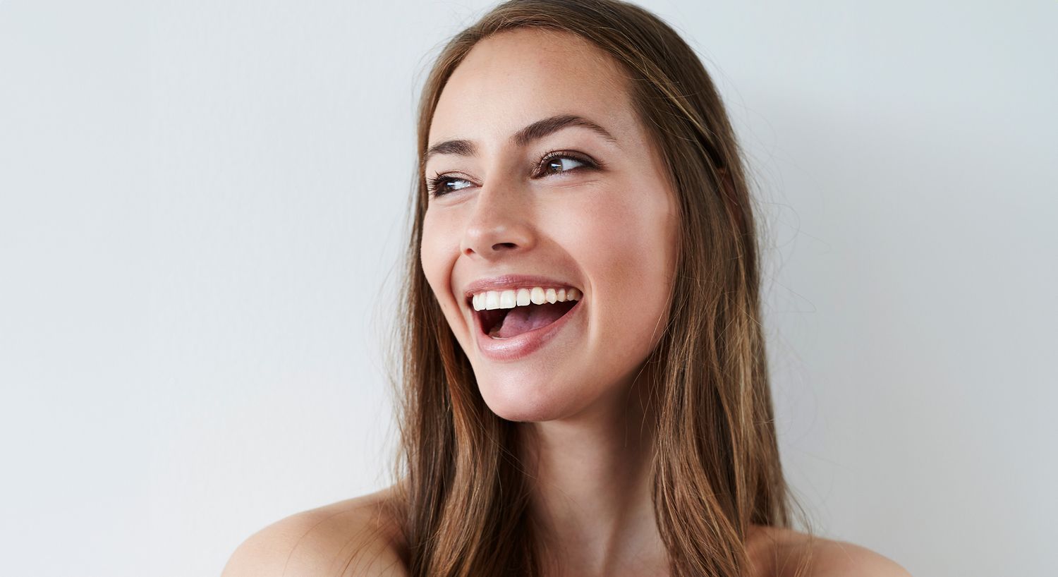 Smiling woman with medium brown hair and blue eyes.