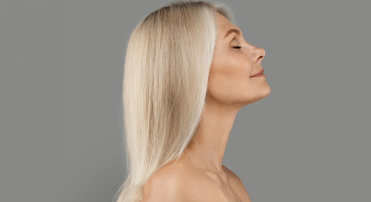 Woman with long blonde hair, side profile.